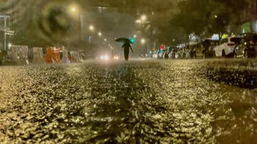 A person makes their way in rainfall from the remnants of Hurricane Ida on September 1, 2021, in the Bronx borough of New York City. The once category 4 hurricane passed through New York City, dumping 3.15 inches of rain in the span of an hour at Central Park. (AFP)
