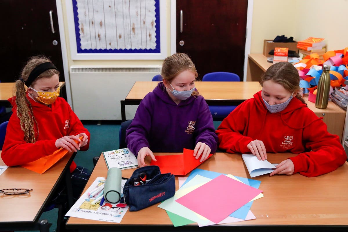 Students fold paper during a lesson at Heath Mount school as schools reopen in England, amid the coronavirus disease (COVID-19) pandemic, in Watton at Stone, Hertfordshire, Britain. (Reuters)