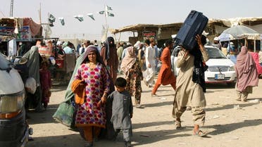 Members of a family from Afghanistan with their belongings cross into Pakistan at the Friendship Gate crossing point at the Pakistan-Afghanistan border town of Chaman, Pakistan, on September 3, 2021. (Reuters)