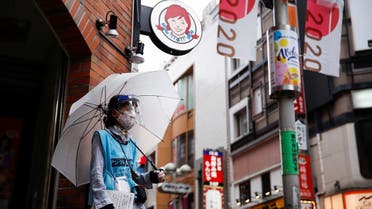Woman who does street surveys wears a mask and a face shield, during a state of emergency amid the coronavirus disease (COVID-19) outbreak, in Tokyo, Japan August 29, 2021. (Reuters)