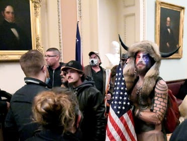 Jacob Anthony Chansley of Arizona stands with other supporters of U.S. President Donald Trump as they demonstrate on the second floor of the U.S. Capitol near the entrance to the Senate after breaching security defenses, in Washington, U.S., January 6, 2021. (File Photo: Reuters)