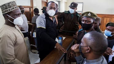 Tanzania's main opposition party, the Party for Democracy and Progress, also known as Chadema, leader Freeman Mbowe is escorted as he arrives at the Kisutu Resident Magistrate Court, where he is facing terrorism-related charges, in Dar Es Salaam, Tanzania August 6, 2021. (Reuters)