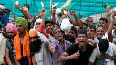 People shout slogans during a Maha Panchayat or grand village council meeting as part of a farmers' protest against farm laws in Muzaffarnagar in the northern state of Uttar Pradesh, India, September 5, 2021. (Reuters)