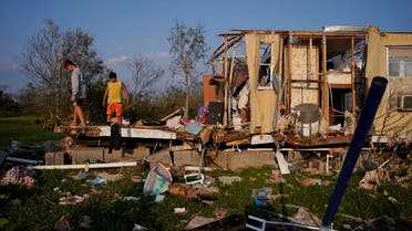 Aiden Locobon, left, and Rogelio Paredes look through the remnants of their family's home destroyed by Hurricane Ida, Saturday, Sept. 4, 2021, in Dulac, La. (AP)