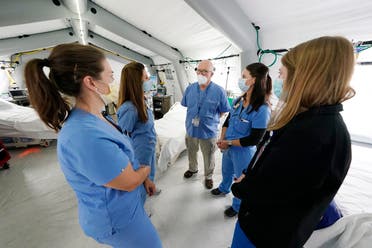 Medical staff confer in one of four wards that are part of the 32-bed Samaritan's Purse Emergency Field Hospital set up in one of the University of Mississippi Medical Center's parking garages, Tuesday, Aug. 17, 2021, in Jackson, Miss. (AP)
