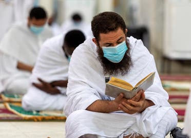 A Muslim pilgrim wearing a protective mask, reads the Quran inside Namira Mosque in Arafat to mark Haj's most important day, Day of Arafat, during his Hajj pilgrimage amid the coronavirus disease (COVID-19) pandemic, outside the holy city of Mecca. (Reuters)