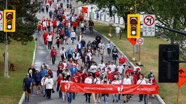 Supporters of Michael Kovrig and Michael Spavor march to mark 1,000 days since the Canadians were arrested in China, during a protest in Ottawa, Ontario, Canada September 5, 2021. (Reuters)