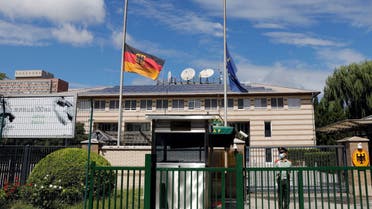 The German and European Union flags fly at half mast after German ambassador to China Jan Hecker passed away, at the Germany embassy in Beijing, China September 6, 2021. REUTERS/Carlos Garcia Rawlins