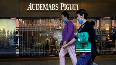 Visitors to a mall walk past the Audemars Piguet store in Beijing on September 6, 2021. (AP)