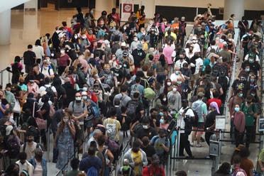 People stand in line to get through the TSA security checkpoint at Louis Armstrong New Orleans International Airport on August 28, 2021 in New Orleans, Louisiana. (AFP)
