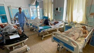 Wounded Afghan men receive treatment at a hospital after explosions outside airport in Kabul, Afghanistan August 27, 2021. (Reuters) 