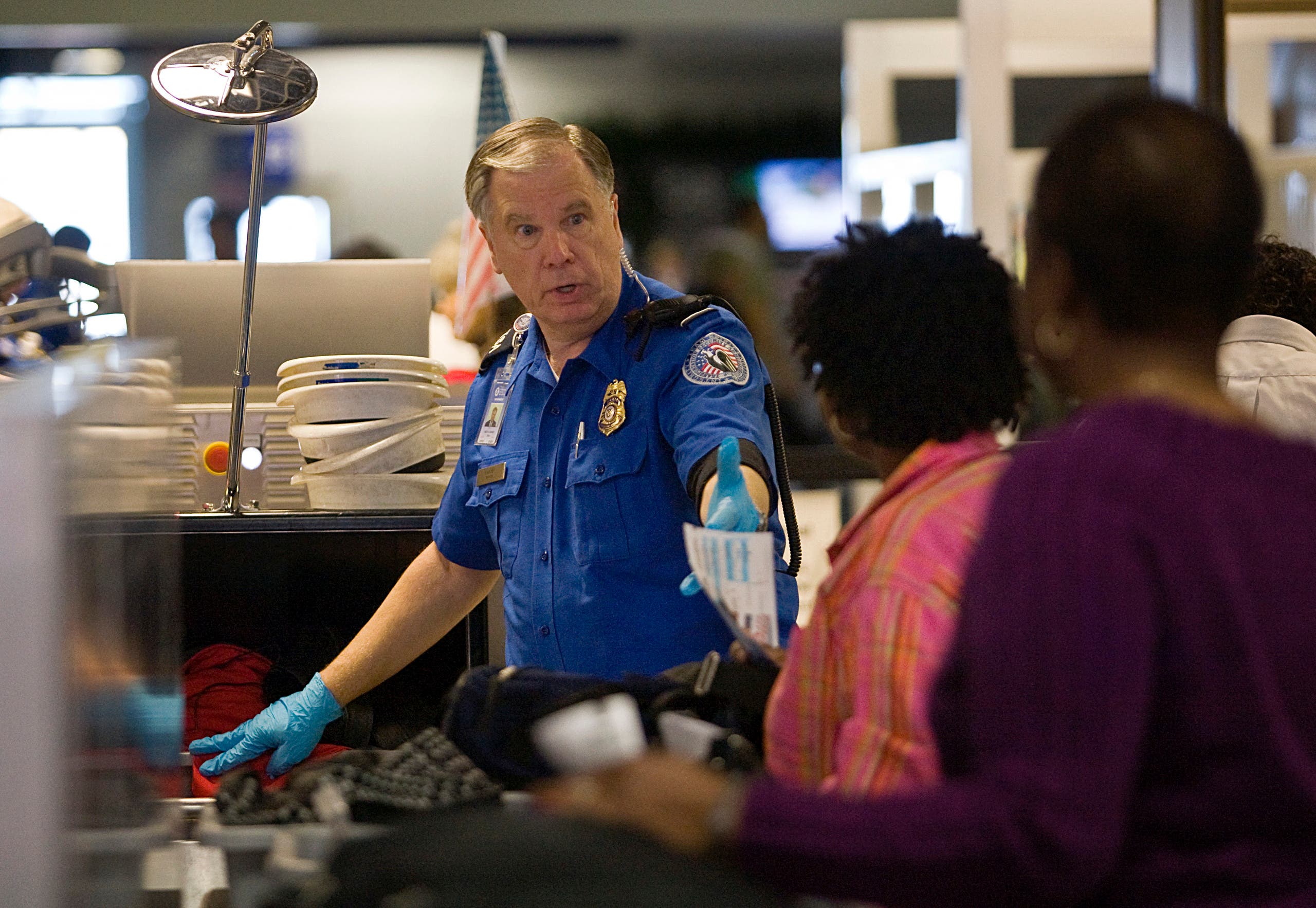 A TSA officer screens airline passengers in Terminal C at Dallas/Fort Worth International Airport December 27, 2009. (AFP)