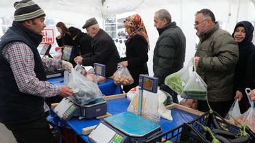 People queue to buy vegetables at a tent set up by the Ankara metropolitan municipality in the Çankaya district of Ankara on February 13, 2019. (AFP)
