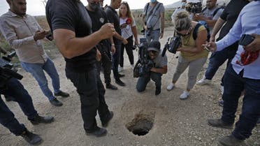 Police and journalists gather around a hole used by six Palestinians to escape from the Gilboa Prison after they dug a tunnel beneath a sink, in northern Israel on September 6, 2021. (AFP)