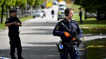 Police are seen near the scene of an apparent attack at a school in Esloev, southern Sweden, on August 19, 2021. (AFP)