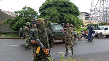 Army soldiers hold a checkpoint after the uprising that led to the toppling of President Alpha Conde in Kaloum neighborhood of Conakry in Guinea, September 6, 2021. (Reuters/Souleymane Camara)