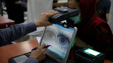  In this June 30, 2021, file photo an employee scans the eyes of a woman for biometric data needed to apply for a passport, at the passport office in Kabul, Afghanistan. (AP)