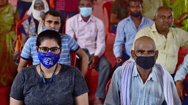People wait for their turn to get inoculated with the dose of the Covishield vaccine against the Covid-19 coronavirus at a hospital in Allahabad on September 6, 2021. (AFP)