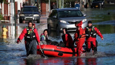 First responders pull local residents trapped by floodwaters after the remnants of Tropical Storm Ida in Mamaroneck, New York, Sept. 2, 2021. (Reuters)