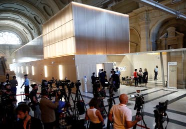 Journalists work in front of the temporary courtroom set up at during the start of the trial of the Paris' November 2015 attacks at the Paris courthouse on the Ile de la Cite, in Paris, France, September 8, 2021. (Reuters)