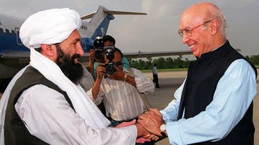 File photo of Afghan Taliban foreign minister Mulla Mohammad Hassan Akhund (L) at an Air Force base in Rawalpindi, some 25 kilometers from Islamabad, meeting his Pakistani counterpart Sartaj Aziz on August 24, 1999. (AFP)