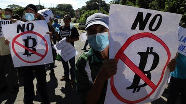 Farmers hold signs emblazoned with messages against the country adopting Bitcoin as legal tender, during a protest along the Pan-American Highway, in San Vicente, El Salvador, Tuesday, Sept. 7, 2021. (AP)