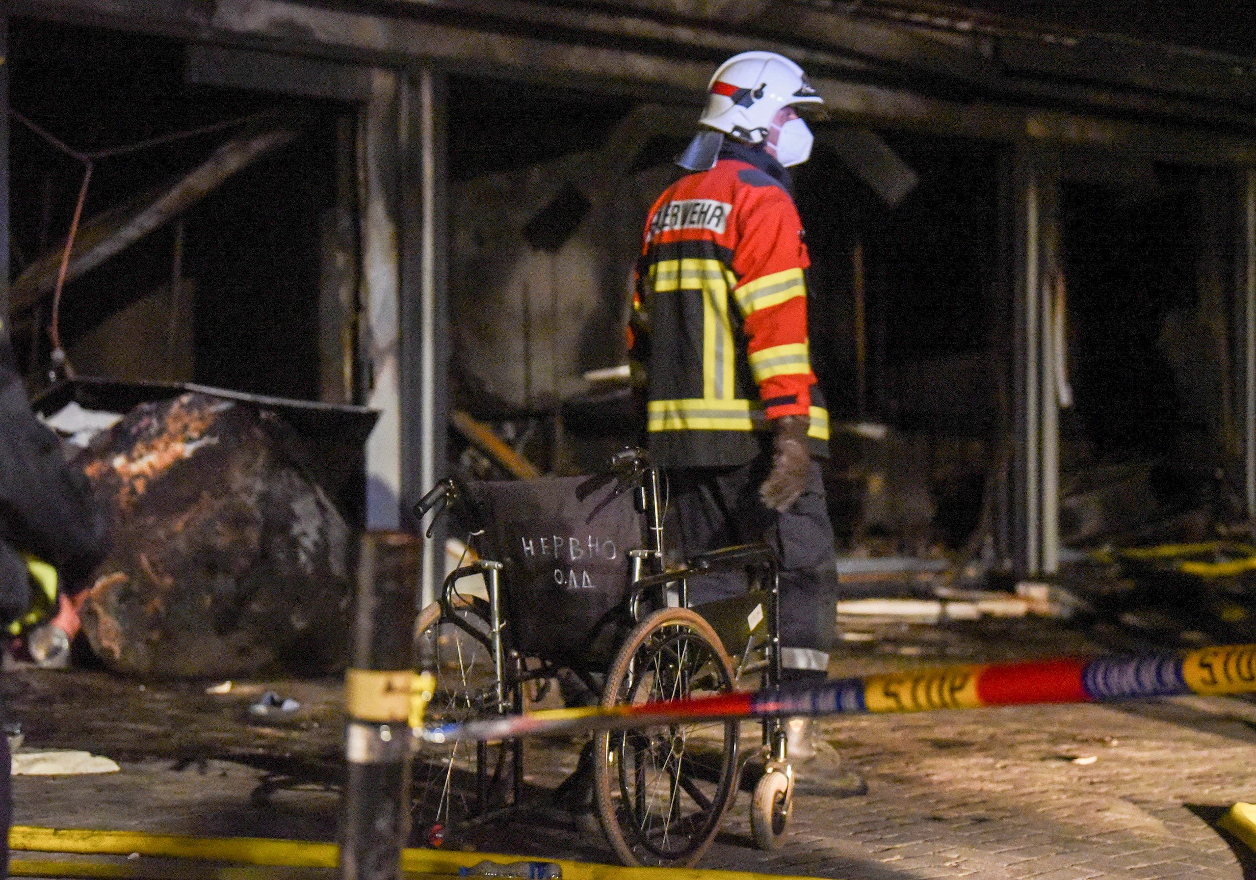 Police and firefighters inspect the scene at a COVID-19 clinic after a fire broke out, in Tetovo, North Macedonia on September 8, 2021. (AFP)