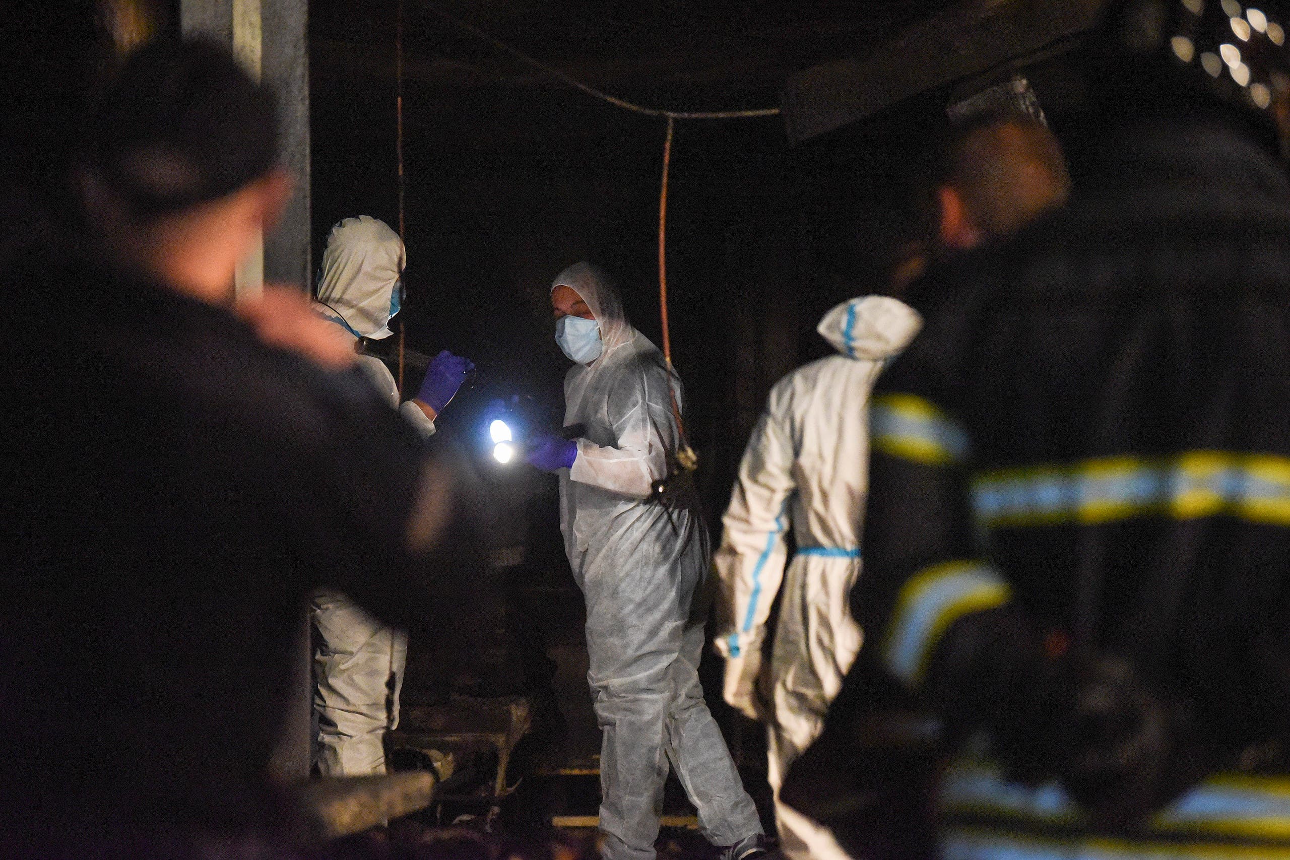 Police and firefighters inspect the scene at a COVID-19 clinic after a fire broke out, in Tetovo, North Macedonia on September 8, 2021. (AFP)