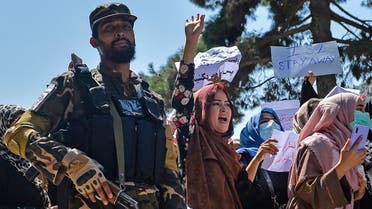Afghan women shout slogans next to a Taliban fighter during a demonstration in Kabul. (AFP)