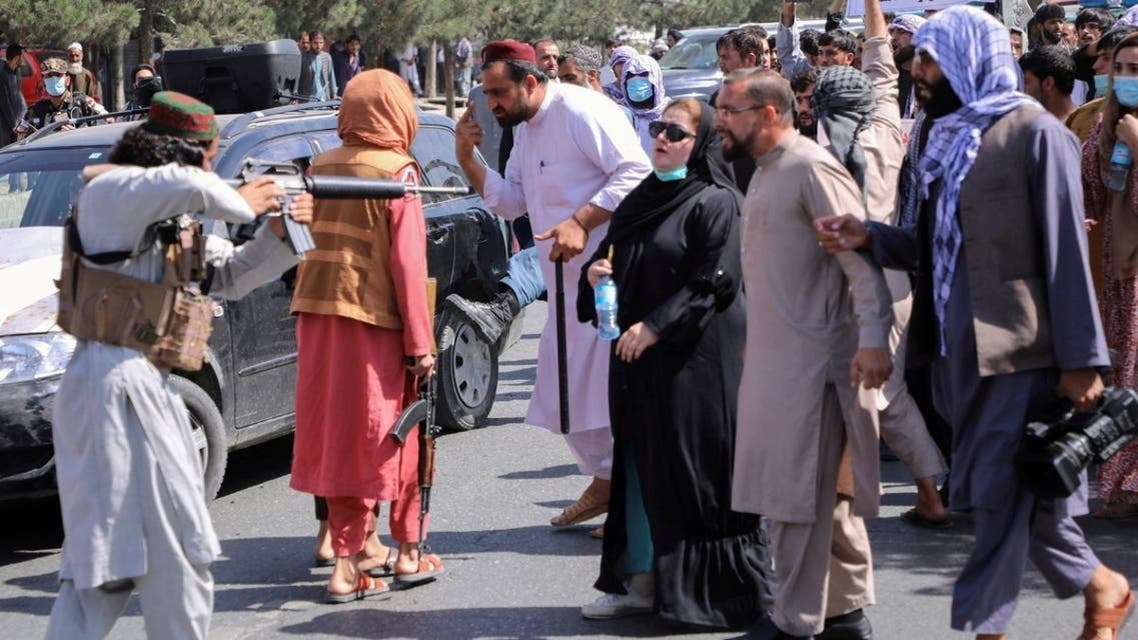 Taliban militants point a gun at protesters. (File Photo: AFP)