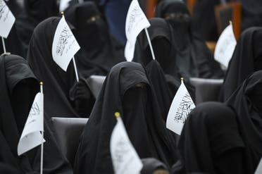 Veiled students hold Taliban flags as they listen a speaker before a pro-Taliban rally at the Shaheed Rabbani Education University in Kabul on September 11, 2021. (AFP)