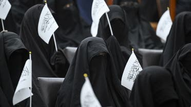 Veiled students hold Taliban flags as they listen a speaker before a pro-Taliban rally at the Shaheed Rabbani Education University in Kabul on September 11, 2021. (AFP)