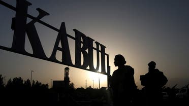Taliban soldiers stand in front of a sign at the international airport in Kabul, Afghanistan, September 9, 2021. (Reuters)