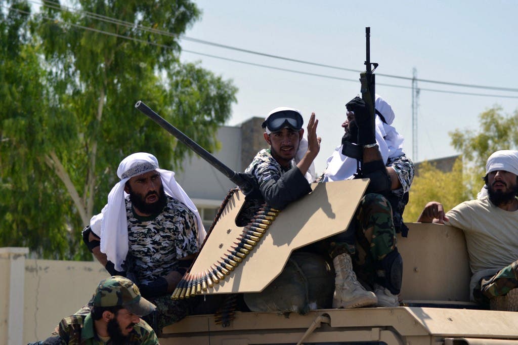 Taliban fighters atop a Humvee vehicle parade along a road to celebrate after the US pulled all its troops out of Afghanistan, in Kandahar on September 1, 2021 following the Taliban’s military takeover of the country. (AFP)