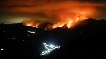 A wildfire is seen at night on Sierra Bermeja Mountain, near the towns of Genalguacil (L) and Benarraba (bottom), southern Spain, September 10, 2021. Picture taken with a long exposure. (Reuters)