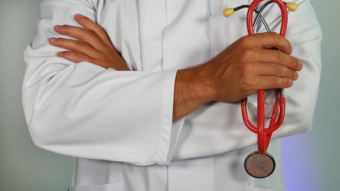 A doctor is pictured in a white coat holding a stethoscope. (Online Marketing, Unsplash)