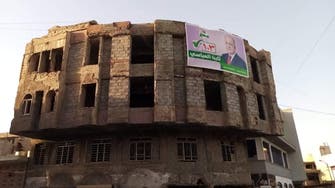 غضب في الموصل.. مرشحون يرفعون صورهم فوق الأنقاض
