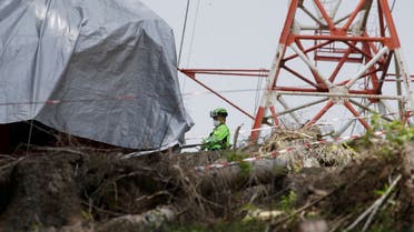 Rescuers search for evidence in the wreckage of a cable car after it collapsed near the summit of the Stresa-Mottarone line in the Piedmont region, northern Italy, Wednesday, May 26, 2021.  (AP)