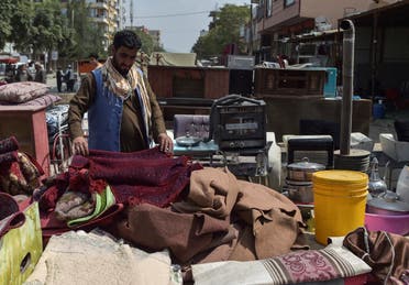 This photo taken on September 12, 2021 shows a man looking at secondhand household items for sale at a market in the northwest neighbourhood of Khair Khana in Kabul. (AFP)
