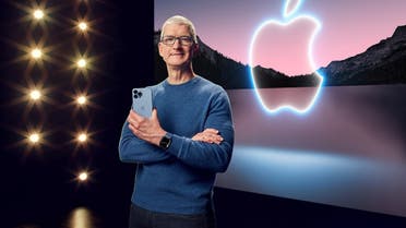 Apple CEO Tim Cook holds the iPhone 13 Pro Max and Apple Watch Series 7 during a special event at Apple Park in Cupertino, California broadcast September 14, 2021. (Reuters)