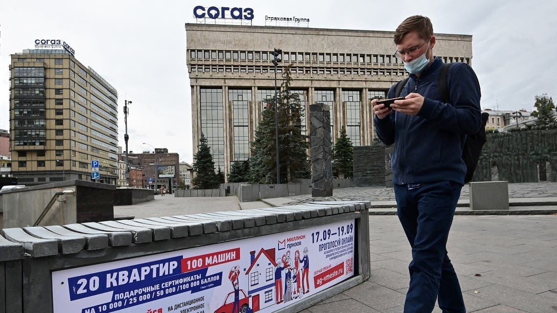 A man walks past a poster announcing the upcoming Russian parliamentary and local elections in Moscow on September 14, 2021. (Yuri Kadobnov/AFP)
