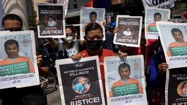 Protesters hold photographs of alleged extra-judicial killings victims and mock mugshots of President Rodrigo Duterte, during a protest to commemorate Duterte's final year in office, in Manila, Philippines, June 30, 2021. (Reuters)