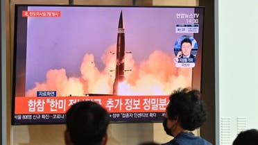 People watch a television news broadcast showing file footage of a North Korean missile test, at a railway station in Seoul on September 15, 2021. (AFP)
