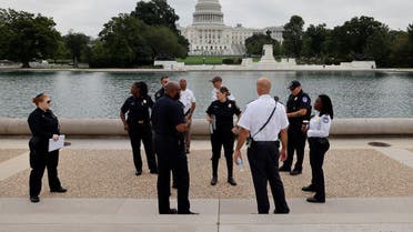US Capitol Police officials survey the area around the Capitol reflecting pool ahead of an expected rally Saturday in support of the Jan. 6 defendants in Washington, US September 16, 2021. (Reuters/Jonathan Ernst)