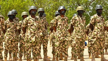 Soldiers stand on guard during Nigerian President Muhammadu Buhari's visit to the Maimalari Barracks in Maiduguri on June 17, 2021. (AFP)