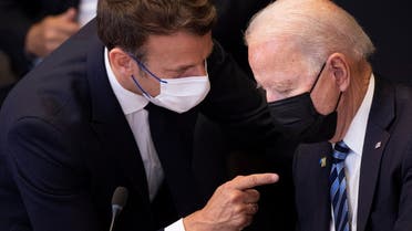France's President Emmanuel Macron (L) talks to US President Joe Biden at the NATO headquarters in Brussels on June 14, 2021. (AFP)