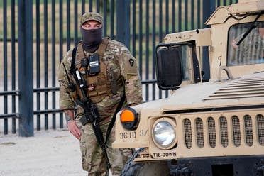 National Guardsmen stands watch over a fence near the International bridge where thousands of Haitian migrants have created a makeshift camp, Saturday, Sept. 18, 2021, in Del Rio, Texas. (AP)