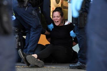 A protester is detained by Victoria police during a The Worldwide Rally for Freedom demonstration in Melbourne, Australia September 18, 2021. (Reuters)