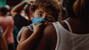 Child wearing a mask to protect against COVID-19 infection. (Unsplash, Taylor Brandon)