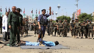 An executioner gestures before he executes a man convicted of involvement in the 2018 killing of top Houthi leader Saleh al-Samad, at Tahrir Square in Sanaa, Yemen September 18, 2021. (Reuters)